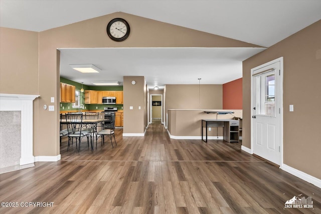 8041 Northwind Ave, Anchorage, AK 99504 - living room with dark wood-style flooring, lofted ceiling, and baseboards