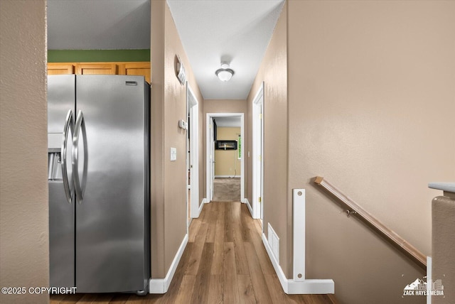8041 Northwind Ave, Anchorage, AK 99504 - hall featuring an upstairs landing, wood finished floors, and baseboards