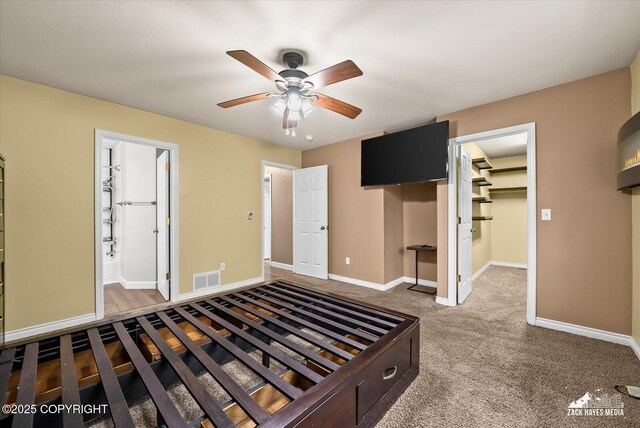 8041 Northwind Ave, Anchorage, AK 99504 - unfurnished bedroom with a spacious closet, baseboards, a closet, ceiling fan, and connected bathroom