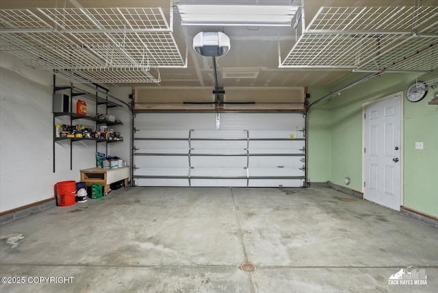 8041 Northwind Ave, Anchorage, AK 99504 - garage featuring a garage door opener and baseboards
