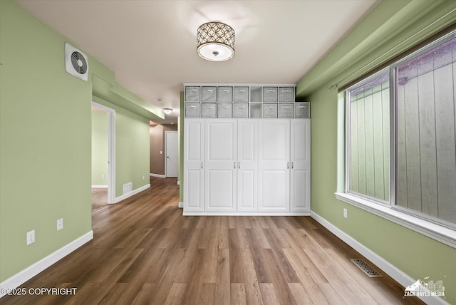8041 Northwind Ave, Anchorage, AK 99504 - unfurnished bedroom featuring wood finished floors and baseboards