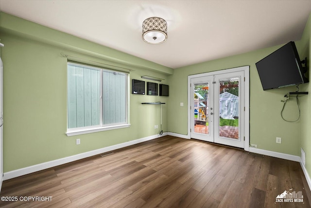 8041 Northwind Ave, Anchorage, AK 99504 - unfurnished dining area with french doors, wood finished floors, and baseboards