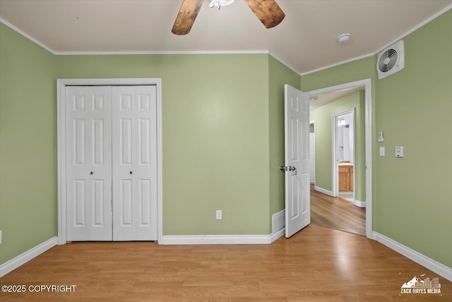 8041 Northwind Ave, Anchorage, AK 99504 - unfurnished bedroom featuring light wood-style flooring, crown molding, a closet, baseboards, and a ceiling fan