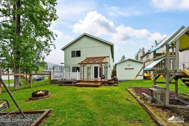 8041 Northwind Ave, Anchorage, AK 99504 - back of house with an outdoor fire pit and a deck