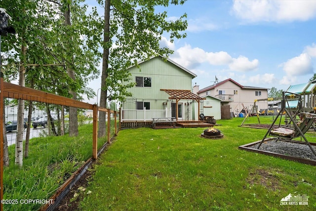 8041 Northwind Ave, Anchorage, AK 99504 - rear view of property with a fire pit and a wooden deck
