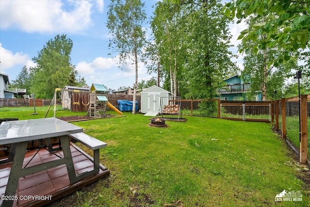 8041 Northwind Ave, Anchorage, AK 99504 - view of yard with a playground, an outdoor fire pit, and outdoor dining space