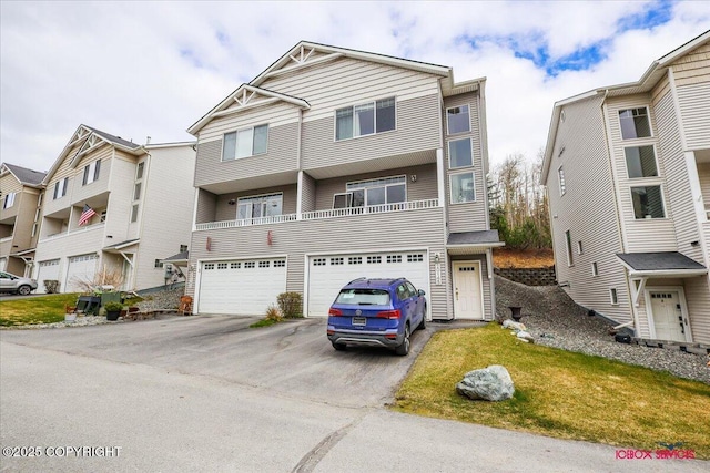 townhome / multi-family property with driveway and a garage
