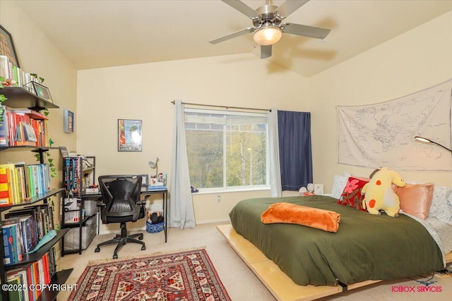 carpeted bedroom with lofted ceiling, a desk, and ceiling fan