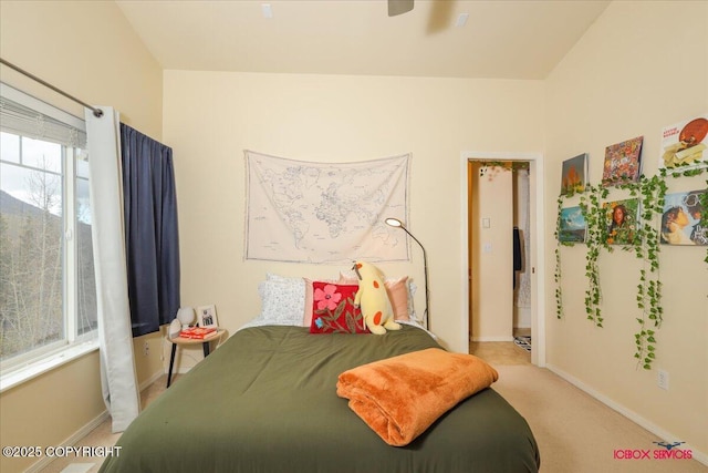 bedroom with baseboards and light colored carpet