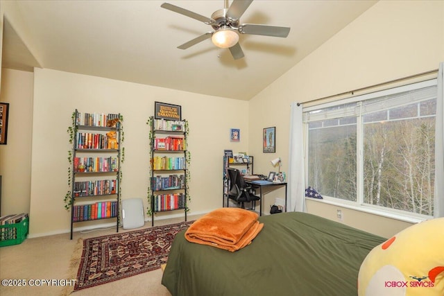 carpeted bedroom with lofted ceiling and baseboards