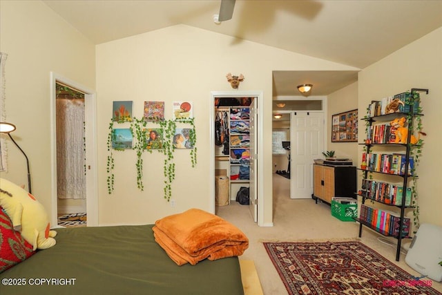 bedroom with a walk in closet, carpet floors, vaulted ceiling, and a closet