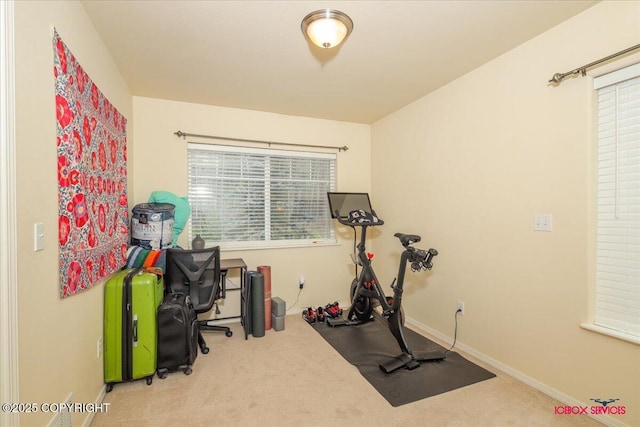 workout room featuring carpet floors and baseboards