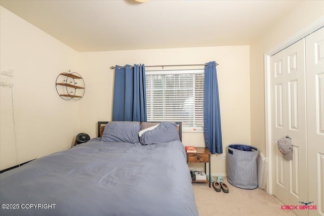bedroom with light carpet and a closet