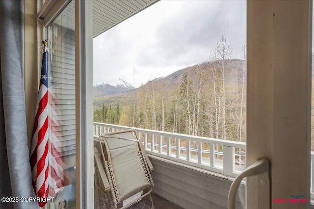 balcony with a view of trees and a mountain view