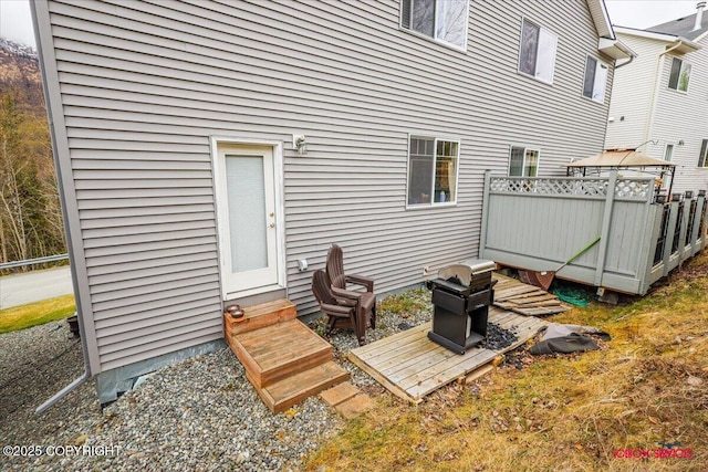back of house featuring entry steps and fence