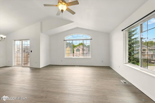 2308 Casey Cusack Loop, Anchorage, AK 99515 - empty room with healthy amount of natural light, lofted ceiling, and wood finished floors
