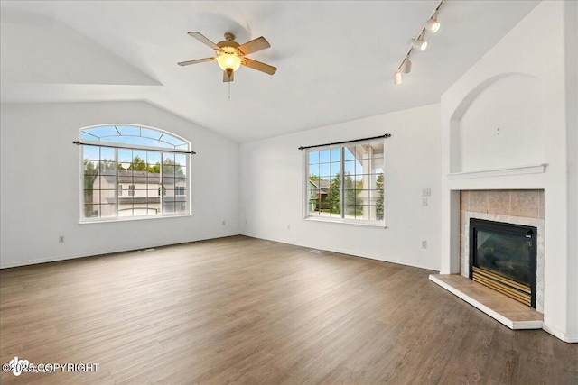 2308 Casey Cusack Loop, Anchorage, AK 99515 - unfurnished living room with lofted ceiling, a fireplace, wood finished floors, a ceiling fan, and rail lighting