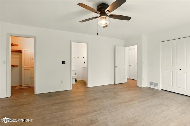 2308 Casey Cusack Loop, Anchorage, AK 99515 - unfurnished bedroom with a closet, wood finished floors, ensuite bathroom, and baseboards