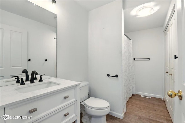 2308 Casey Cusack Loop, Anchorage, AK 99515 - full bathroom with vanity, wood finished floors, toilet, and baseboards