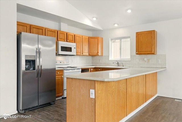 2308 Casey Cusack Loop, Anchorage, AK 99515 - kitchen featuring white appliances, a peninsula, dark wood finished floors, backsplash, and recessed lighting