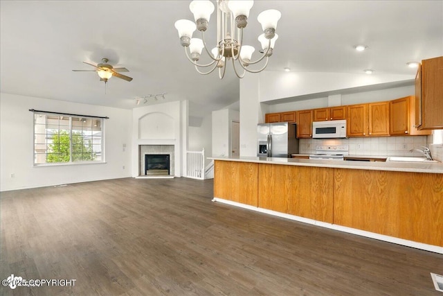 2308 Casey Cusack Loop, Anchorage, AK 99515 - kitchen featuring white appliances, a sink, lofted ceiling, brown cabinets, and light countertops