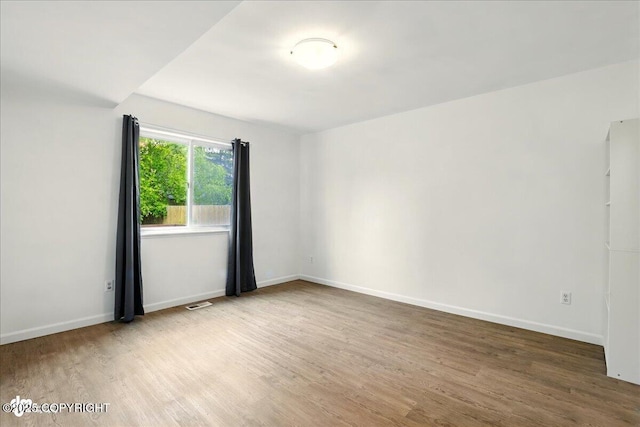 2308 Casey Cusack Loop, Anchorage, AK 99515 - spare room featuring wood finished floors and baseboards