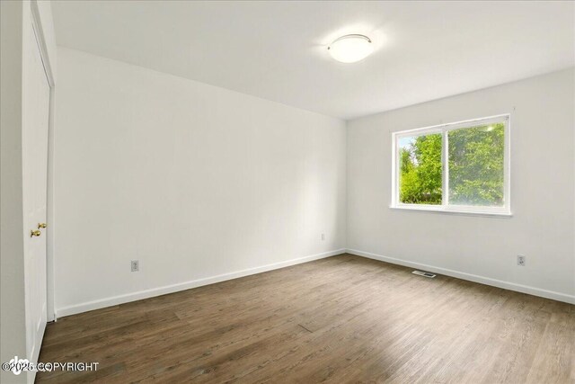 2308 Casey Cusack Loop, Anchorage, AK 99515 - empty room with dark wood-style flooring and baseboards
