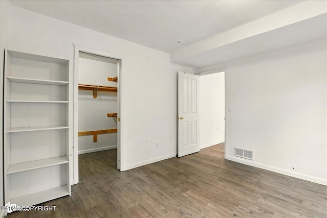 2308 Casey Cusack Loop, Anchorage, AK 99515 - unfurnished bedroom with wood finished floors, baseboards, a spacious closet, and a closet