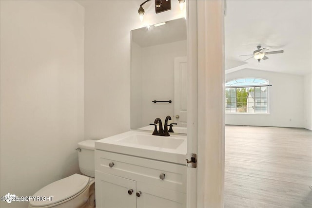 2308 Casey Cusack Loop, Anchorage, AK 99515 - half bathroom with vanity, toilet, wood finished floors, ceiling fan, and vaulted ceiling