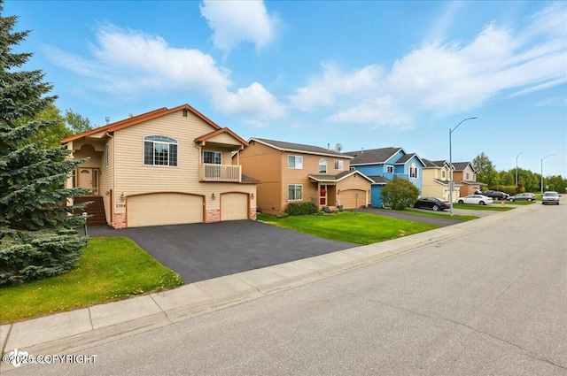 2308 Casey Cusack Loop, Anchorage, AK 99515 - view of front of home featuring an attached garage, asphalt driveway, a residential view, and a front yard