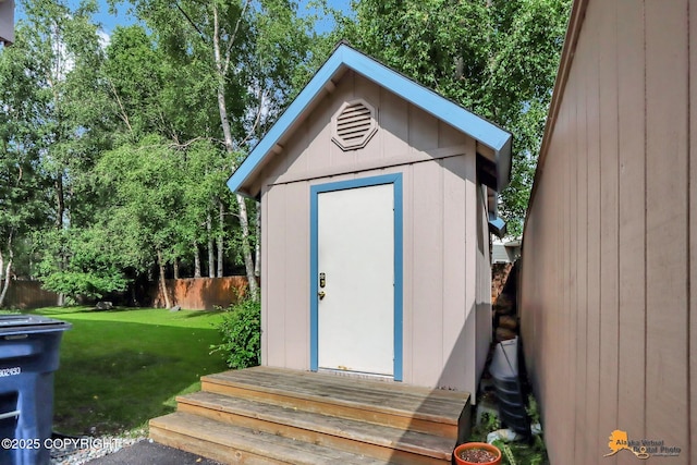 view of shed featuring fence
