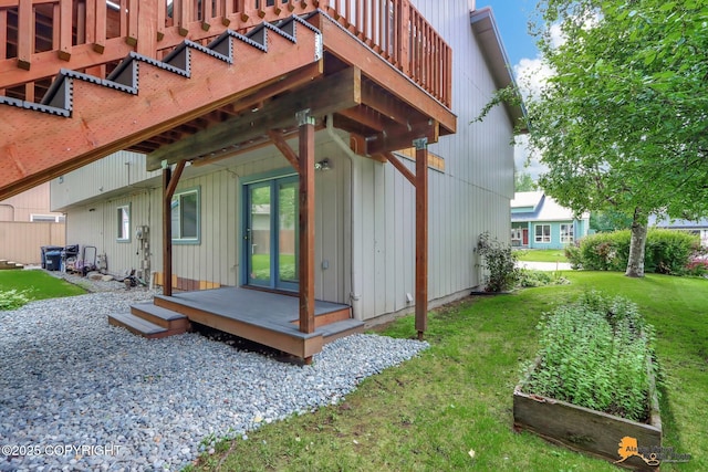 back of house featuring a lawn and a garden