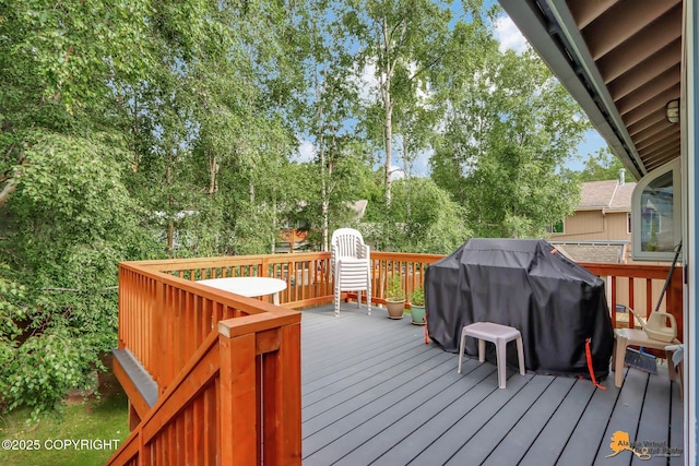 wooden deck featuring area for grilling