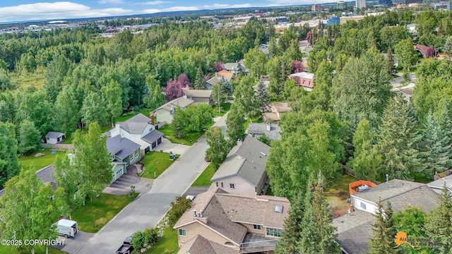 birds eye view of property featuring a residential view and a view of trees