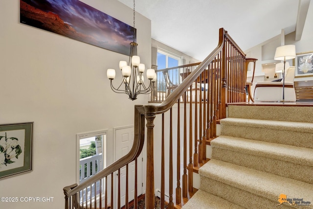 stairway featuring an inviting chandelier, a healthy amount of sunlight, and high vaulted ceiling