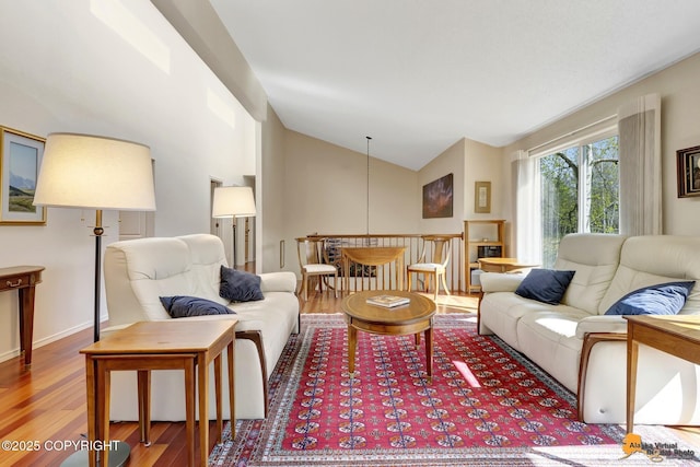 living area featuring high vaulted ceiling and wood finished floors