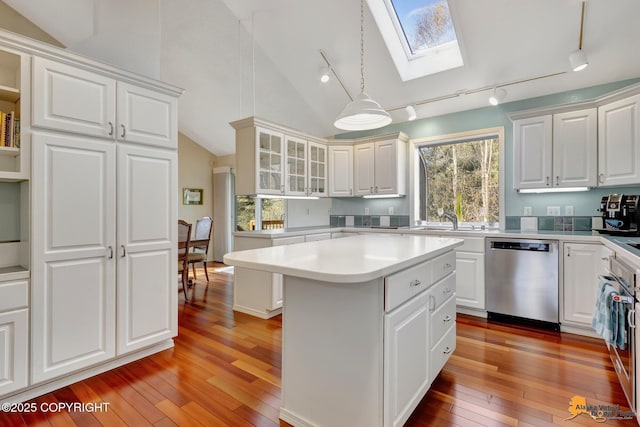 kitchen with track lighting, light countertops, dishwasher, and light wood-type flooring