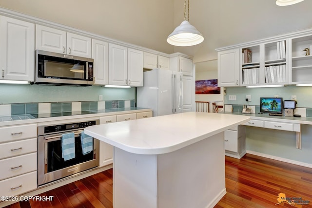 kitchen featuring white cabinets, open shelves, appliances with stainless steel finishes, and hardwood / wood-style flooring
