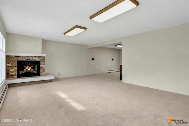 unfurnished living room featuring carpet, a brick fireplace, and baseboard heating
