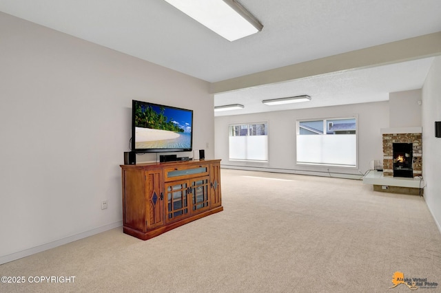 carpeted living room featuring baseboards, a baseboard heating unit, and a stone fireplace