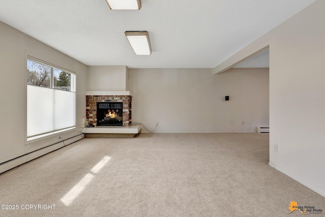 unfurnished living room with carpet floors, a baseboard heating unit, baseboard heating, and a fireplace