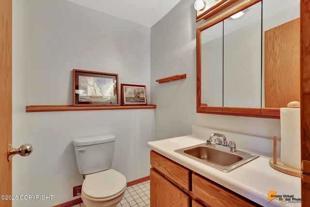 6517 S Becky Ln, Wasilla, AK 99652 - bathroom featuring toilet, vanity, and baseboards