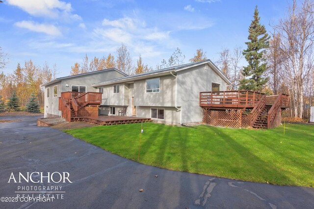 view of front of home featuring a wooden deck and a front yard