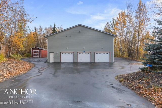 view of property exterior with an outbuilding, driveway, and a garage