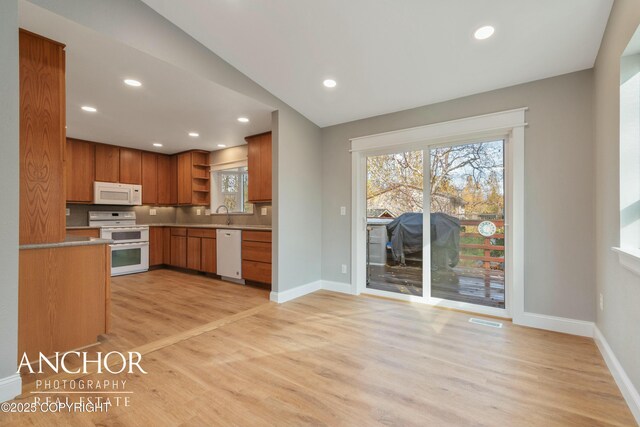 kitchen with open shelves, white appliances, plenty of natural light, visible vents, and light wood-style flooring