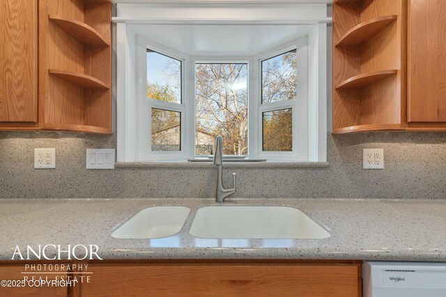 kitchen featuring a sink, white dishwasher, open shelves, and a wealth of natural light