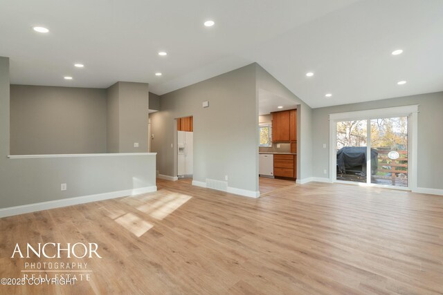 unfurnished living room featuring baseboards, visible vents, recessed lighting, and light wood finished floors