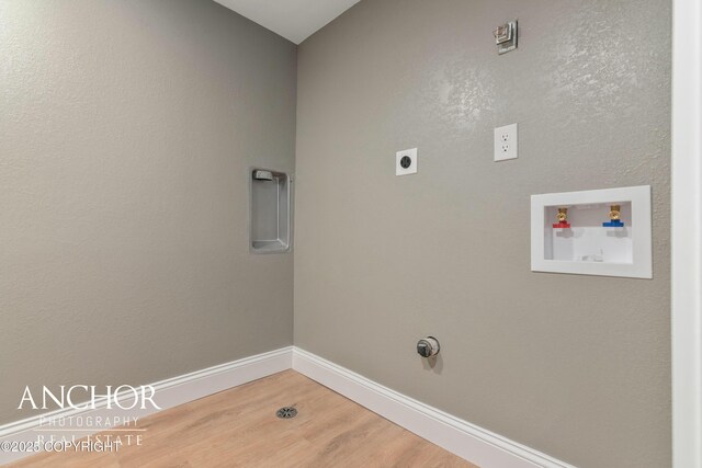 laundry area with washer hookup, baseboards, wood finished floors, laundry area, and electric dryer hookup