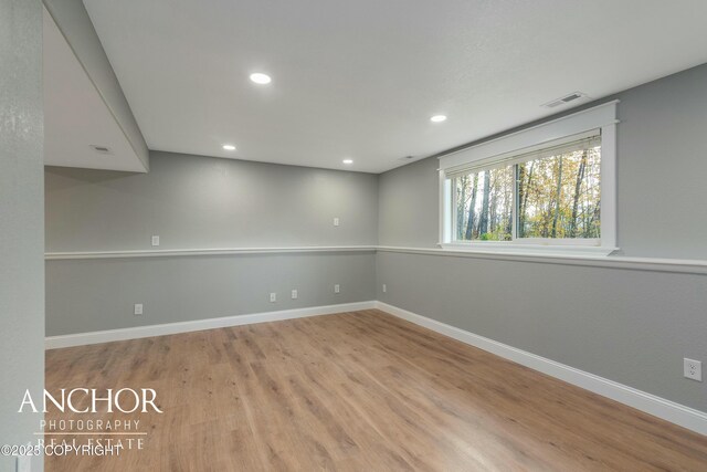 empty room with baseboards, visible vents, and recessed lighting