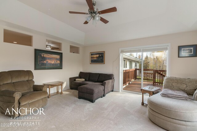 living room with baseboards, lofted ceiling, carpet flooring, and a ceiling fan
